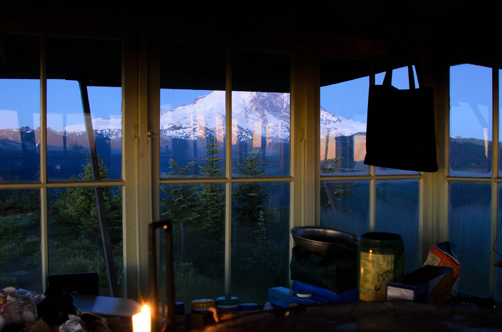 View from inside cabin looking at snowy mountain peaks