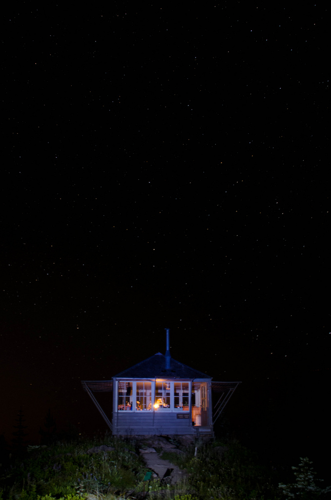 Mountaintop cabin under starry sky
