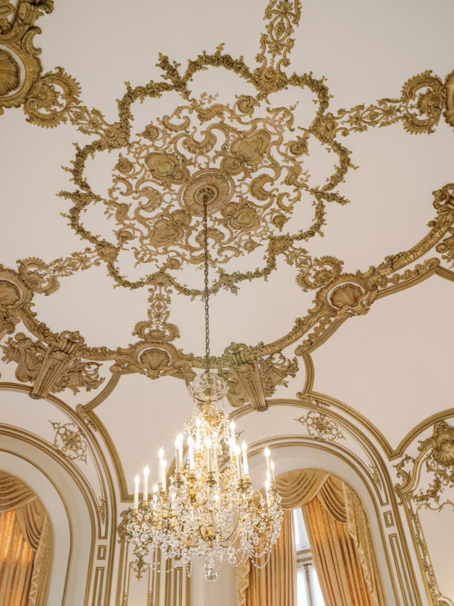 Looking up, the ceiling details in gold and white at The Perry Belmont House in Washington, D.C.